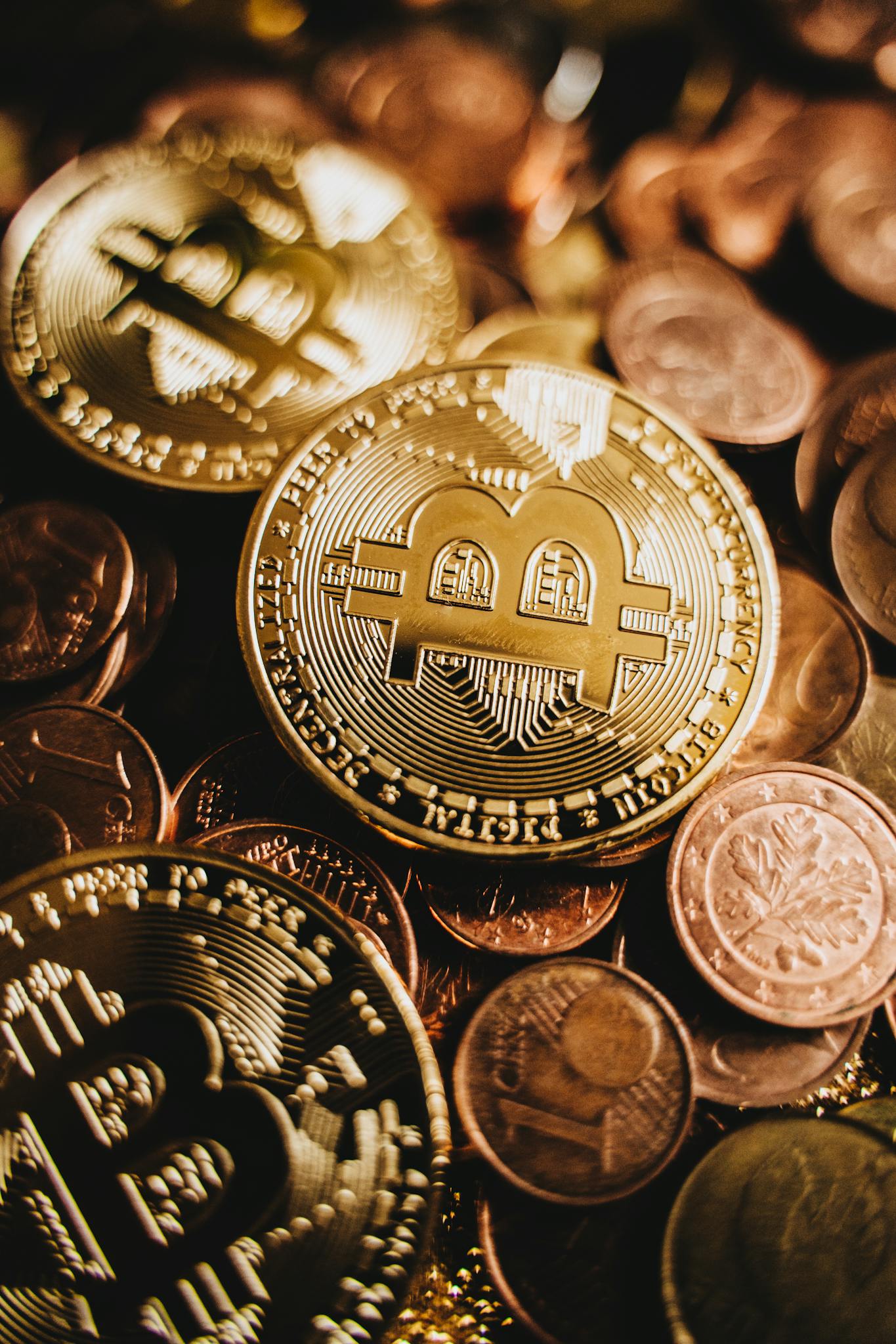 A detailed view of bitcoins amidst various coins showcasing digital currency and wealth.
